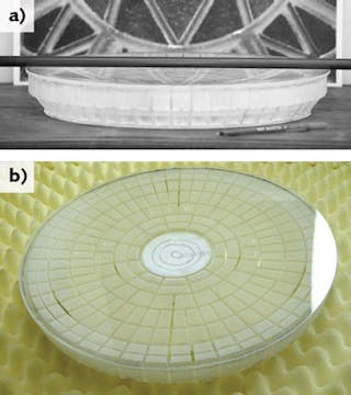 FIGURE 1. A bubble-free, double-conical, polished lightweight mirror has a 396 mm CA (a), and a view from the side shows the rib design (b).