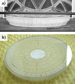 FIGURE 1. A bubble-free, double-conical, polished lightweight mirror has a 396 mm CA (a), and a view from the side shows the rib design (b). FIGURE 1. A bubble-free, double-conical, polished lightweight mirror has a 396 mm CA (a), and a view from the side shows the rib design (b).