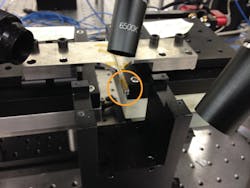 FIGURE 1. Optical fibers ride on finger probes (circled), enabling alignment of multiple fibers with accuracies better than 100 nm. FIGURE 1. Optical fibers ride on finger probes (circled), enabling alignment of multiple fibers with accuracies better than 100 nm.