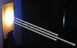 A photo shows nanocrystal-based material converting blue laser emission to white light for combined illumination and data communication (the data is visualized via the artistic binary strings). A photo shows nanocrystal-based material converting blue laser emission to white light for combined illumination and data communication (the data is visualized via the artistic binary strings).