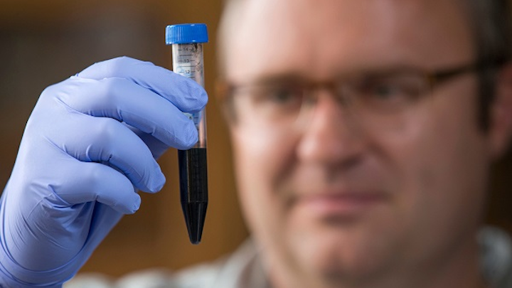 Jonathan Claussen is one of the researchers using lasers to treat paper to make printed graphene electronics. The process improves conductivity and enables flexible, wearable, and low-cost electronics. (Image credit: Christopher Gannon/Iowa State University)