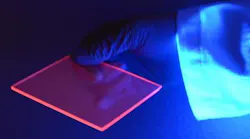 Luminescence from silicon quantum dots excited by UV light highlights the edge of the LSC, which concentrates the visible light given off by the quantum dots.