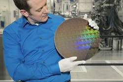 IBM Research scientist Nicolas Loubet holds a wafer of chips with 5nm silicon nanosheet transistors manufactured using an industry-first process that can deliver 40 percent performance enhancement at fixed power, or 75% power savings at matched performance.