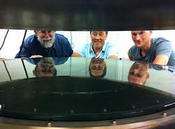 UC Santa Cruz researchers worked with Structured Materials Industries to design and build an atomic layer deposition (ALD) system large enough to accommodate telescope mirrors. Andrew Phillips, Nobuhiko Kobayashi, and David Fryauf (left to right) examine the deposition chamber. UC Santa Cruz researchers worked with Structured Materials Industries to design and build an atomic layer deposition (ALD) system large enough to accommodate telescope mirrors. Andrew Phillips, Nobuhiko Kobayashi, and David Fryauf (left to right) examine the deposition chamber.