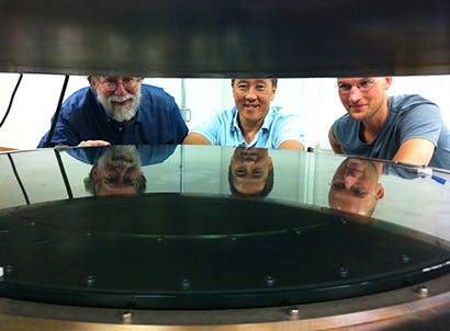 UC Santa Cruz researchers worked with Structured Materials Industries to design and build an atomic layer deposition (ALD) system large enough to accommodate telescope mirrors. Andrew Phillips, Nobuhiko Kobayashi, and David Fryauf (left to right) examine the deposition chamber.