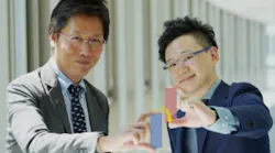 Ryota Kabe and Chihaya Adachi of Kyushu University hold two samples of the organic long-persistent-luminescence material they developed.