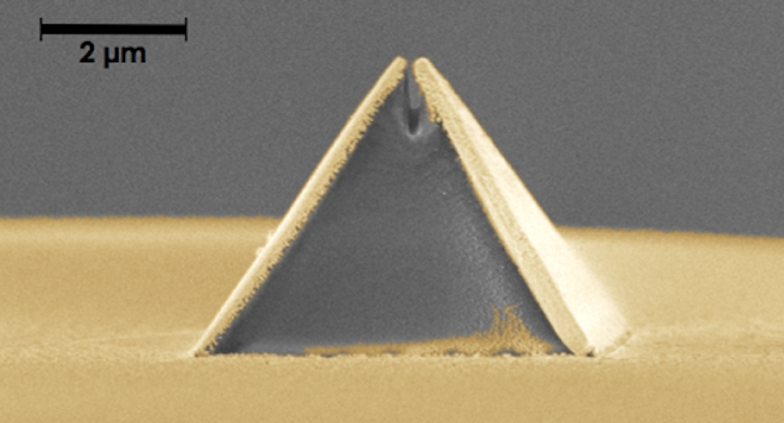 A new process called fiber nanoimprinting speeds fabrication of nanooptical devices, such as this pyramid-shaped Campanile probe imprinted on an optical fiber (captured in a scanning electron microscope image). The gold layer is added after imprinting and the gap at the top is 70 nm wide. (Image credit: Berkeley Lab)