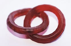 Using the new 'TwoCure' process, a 3D printed ring-in-ring structure is manufactured without support structures and without platform contact. Using the new 'TwoCure' process, a 3D printed ring-in-ring structure is manufactured without support structures and without platform contact.