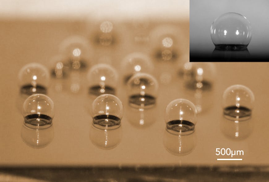 A chip-scale glass microspherical shell sensor array is shown blown on a silicon substrate. Insert is a near-perfect spherical shell.