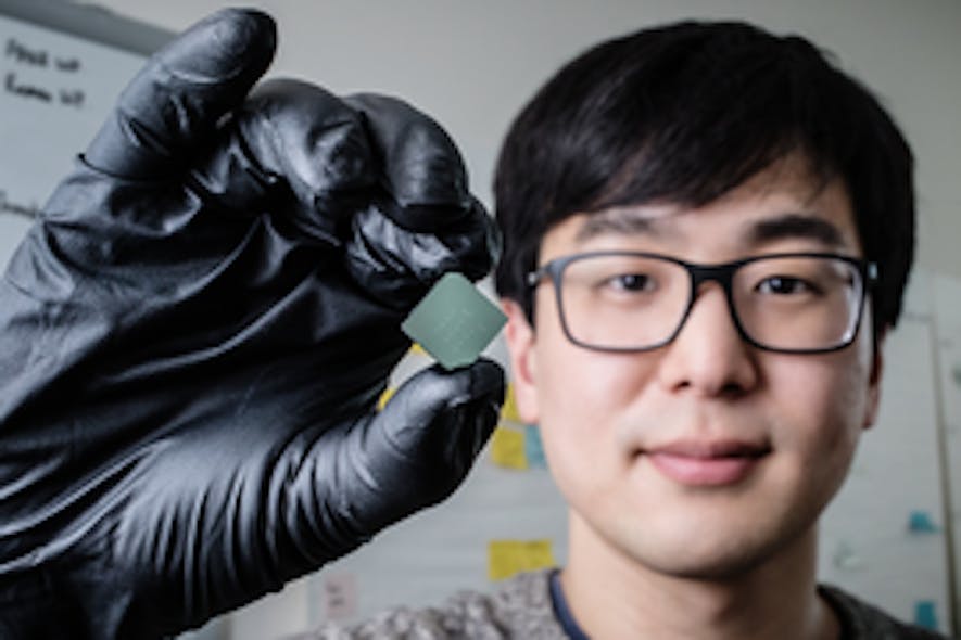 Mechanical science and engineering student and lead author of a new study Benjamin Sohn holds a device that uses sound waves to produce optical diodes tiny enough to fit onto a computer chip.