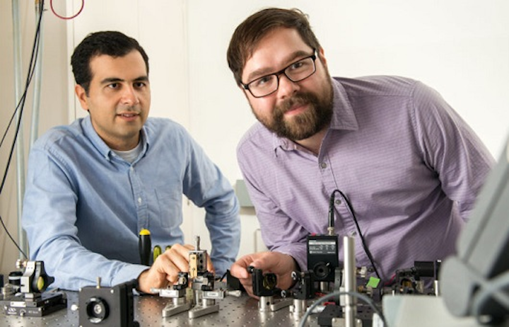 Alireza Marandi, left, and Marc Jankowski prepare to carry out experiments at the optical bench that generate better ultrashort pulses. (Image credit: L.A. Cicero/Stanford University)