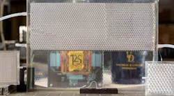 Electrical engineers at the University of Delaware developed their version of smart glass technology. It starts opaque but turns transparent when filled with index-matching fluid, as shown in the bottom portion of this pane.
