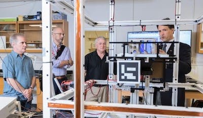Brian Gunter of Georgia Tech shows the small satellite testing facilities in his lab to Xenesis leadership. Shown (l-r) are Neal Campion, Xenesis Strategy Director; Mark LaPenna, Xenesis CEO and founder; Mike Carey, chief strategy officer at Atlas Space Operations, and Gunter.