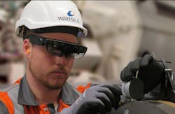 A service engineer at Wärtsilä is using smart glasses when carrying out maintenance work. A service engineer at Wärtsilä is using smart glasses when carrying out maintenance work.