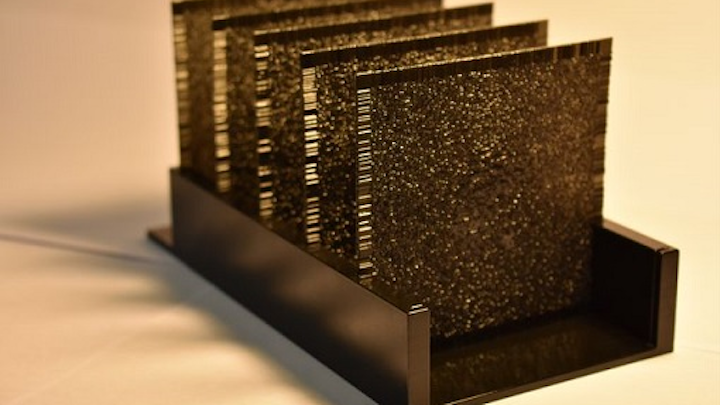An artificial neural network, composed of a series of polymer layers, works using light that travels through it and artificial intelligence algorithms. Each layer is 8 cm square. (Image credit: Ozcan Research Group/UCLA)