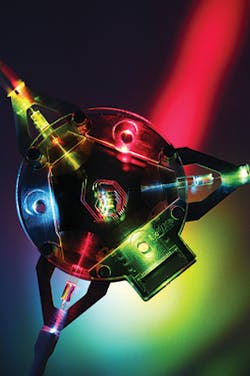 An example of a complex assembly for visible light applications with a triangular-shaped fused silica PIC. An example of a complex assembly for visible light applications with a triangular-shaped fused silica PIC.