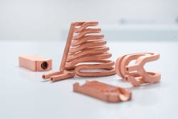 3D-printed components made of pure copper are shown. 3D-printed components made of pure copper are shown.