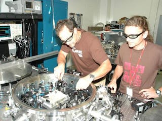 JPL researchers Glenn de Vine and Brent Ware align their LISA laboratory setup. (No, that&apos;s not Bono of U2 on the right.)