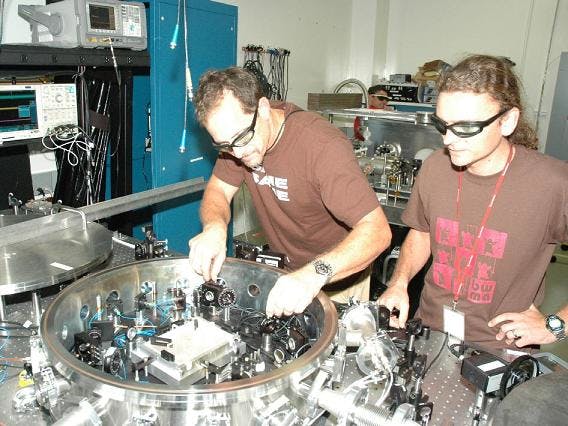 JPL researchers Glenn de Vine and Brent Ware align their LISA laboratory setup. (No, that&apos;s not Bono of U2 on the right.)
