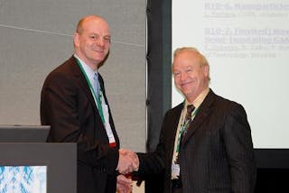 Ralph James (right), co-chairperson of the 17th International Workshop on Room-Temperature Semiconductor Detectors, congratulates Michael Fiederle on winning the research award.