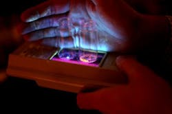 Organic phosphors developed at the University of Michigan glow in blue and orange when triggered by UV light.