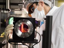 Eduardo Granados, a laser scientist at SLAC, inspects the Ti:sapphire gain crystal at the heart of SLAC's newly upgraded high-power laser system. Eduardo Granados, a laser scientist at SLAC, inspects the Ti:sapphire gain crystal at the heart of SLAC's newly upgraded high-power laser system.