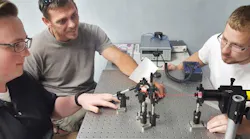 Baker College students Riley Ragsdale, of Clio, Richard Rogers, of Hartland, and Brian Heilner, of Fenton, perform an experiment on the diffraction of monochromatic light in the college’s optics and photonics lab.