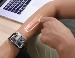The LumiWatch has a built-in picoprojector that provides touchscreen functionality on the wearer’s arm. The LumiWatch has a built-in picoprojector that provides touchscreen functionality on the wearer’s arm.