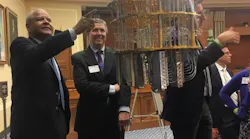 Edward White, Chair of the NPI, and Kent Rochford, CEO of SPIE, with a quantum computer on Capitol Hill.