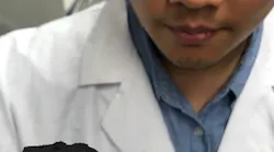 IMAGE:Rice graduate student Duy Xuan Luong suspends a three-dimensional block of laser-induced graphene atop two willows. The lab uses an industrial laser to transform inexpensive polyimide plastic into graphene foam at room temperature, and then binds the sheets to produce lightweight, conductive 3D graphene.