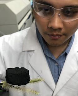 IMAGE:Rice graduate student Duy Xuan Luong suspends a three-dimensional block of laser-induced graphene atop two willows. The lab uses an industrial laser to transform inexpensive polyimide plastic into graphene foam at room temperature, and then binds the sheets to produce lightweight, conductive 3D graphene. IMAGE:Rice graduate student Duy Xuan Luong suspends a three-dimensional block of laser-induced graphene atop two willows. The lab uses an industrial laser to transform inexpensive polyimide plastic into graphene foam at room temperature, and then binds the sheets to produce lightweight, conductive 3D graphene.