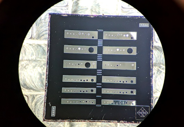 A magnified photograph shows a semiconductor chip containing arrays of crystalline coated micro-cantilevers used to create an experimental apparatus for measuring quantum radiation pressure noise. (Image credit: Crystalline Mirror Solutions)