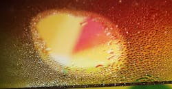 In the ETH lab, shining a light through the center of a transparent pane coated with nanoparticles prevents the lit area from fogging. (Image credit: Christopher Walker/ETH Zurich) In the ETH lab, shining a light through the center of a transparent pane coated with nanoparticles prevents the lit area from fogging. (Image credit: Christopher Walker/ETH Zurich)