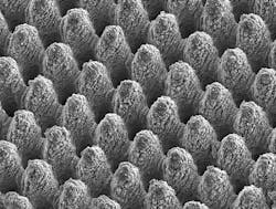 Shown is a laser-machined metal surface with self-cleaning properties. The peak-to-peak distance between the individual structural elements is approximately 10 microns. Shown is a laser-machined metal surface with self-cleaning properties. The peak-to-peak distance between the individual structural elements is approximately 10 microns.