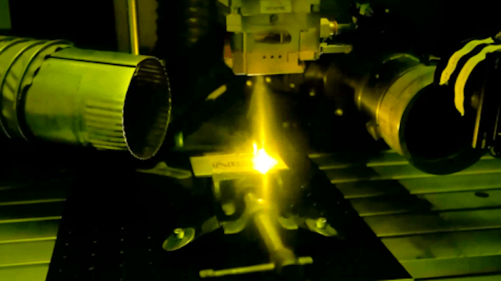 Inside NIST's laser welding booth, a high-power laser melts a piece of metal to form the letters NIST. (Image credit: Paul Williams/NIST)