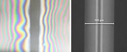 FIGURE 2. Two glass substrates, seen from the top, have been welded by a femtosecond laser, leaving four vertical weld lines surrounded by optical fringes; the inset shows a closeup of one of the lines showing weld width of 100 &mu;m.