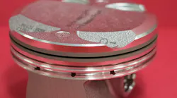 A car engine piston off the production line of a large auto manufacturer is shown; the piston has been treated with a femtosecond laser for enhanced engine performance.