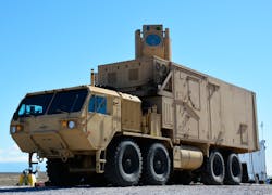 FIGURE 2. The HELMTT truck is used by the Army Space and Missile Defense Command. The 10 kW laser is inside the truck, with the beam director in the box at top. The beam emerges through the large round window. (Photo credit: U.S. Army) FIGURE 2. The HELMTT truck is used by the Army Space and Missile Defense Command. The 10 kW laser is inside the truck, with the beam director in the box at top. The beam emerges through the large round window. (Photo credit: U.S. Army)