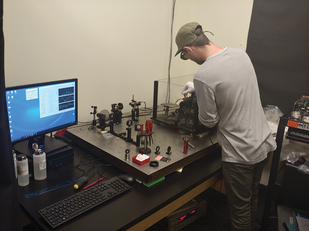 FIGURE 2. An engineer at Optimax takes measurements of coating absorption using a photothermal common-path interferometer (PCI).