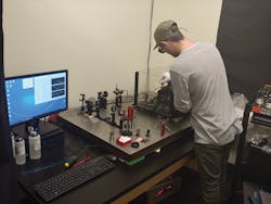 FIGURE 2. An engineer at Optimax takes measurements of coating absorption using a photothermal common-path interferometer (PCI). FIGURE 2. An engineer at Optimax takes measurements of coating absorption using a photothermal common-path interferometer (PCI).