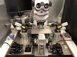 FIGURE 2. The traveling microscope is mounted independently of the electrophysiology recording chamber and four-axis micromanipulators. The entire assembly is surrounded by a Faraday cage to block ambient electrical noise. FIGURE 2. The traveling microscope is mounted independently of the electrophysiology recording chamber and four-axis micromanipulators. The entire assembly is surrounded by a Faraday cage to block ambient electrical noise.