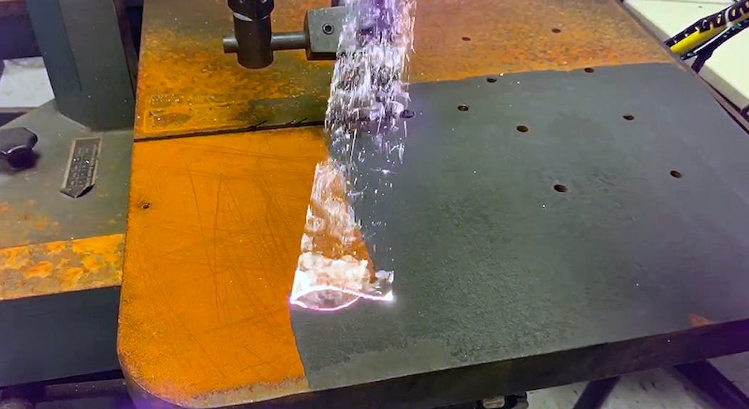 Laser Photonics&apos; 2000 W handheld laser cleaner removes rust from a surface.