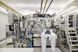 ASML employees work on the final assembly of an NXE:3400B without its panels. ASML employees work on the final assembly of an NXE:3400B without its panels.