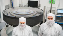 Lawrence Livermore National Laboratory (LLNL) engineer Vincent Riot (left) has worked on the Large Synoptic Survey Telescope (LSST) for more than a decade and has been the full camera project manager since 2017. Riot and LLNL optical engineer Justin Wolfe, the LSST camera optics subsystems manager, stand in front of the LSST main lens assembly. Photo by Farrin Abbott/SLAC National Accelerator Laboratory.