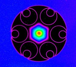 Microscopic cross-section of the record-setting low-loss hollow-core fiber. Thin hollow glass cylinders shown in pink run the length of the fiber, effectively creating bars that prevent the hexagonal light modes trapped in the center of the air-filled core from leaking into the glass. The hollow core, defined by the inner edges of the cylinders, is 37 µm across. Microscopic cross-section of the record-setting low-loss hollow-core fiber. Thin hollow glass cylinders shown in pink run the length of the fiber, effectively creating bars that prevent the hexagonal light modes trapped in the center of the air-filled core from leaking into the glass. The hollow core, defined by the inner edges of the cylinders, is 37 µm across.