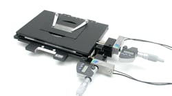 FIGURE 1. The MICI80-KMI53 microscopy stage from Piezosystem Jena, available in both open- and closed-loop versions, can be used for positioning or scanning with sub-nanometer resolution. The ultrastiff flexure design drives the digital micrometer heads with a resolution of 1 µm, a manual range of motion of 25 mm in the x-y axes, and a piezo-based range of motion of 80 µm. A proprietary frame design links the x-y axes in a single piece of metal for superior orthogonality and flatness. A special coil spring system delivers a constant force throughout the manual travel range of the stage, allowing preload optimization over the entire range of travel for extremely low drifting behavior. FIGURE 1. The MICI80-KMI53 microscopy stage from Piezosystem Jena, available in both open- and closed-loop versions, can be used for positioning or scanning with sub-nanometer resolution. The ultrastiff flexure design drives the digital micrometer heads with a resolution of 1 µm, a manual range of motion of 25 mm in the x-y axes, and a piezo-based range of motion of 80 µm. A proprietary frame design links the x-y axes in a single piece of metal for superior orthogonality and flatness. A special coil spring system delivers a constant force throughout the manual travel range of the stage, allowing preload optimization over the entire range of travel for extremely low drifting behavior.