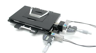 FIGURE 1. The MICI80-KMI53 microscopy stage from Piezosystem Jena, available in both open- and closed-loop versions, can be used for positioning or scanning with sub-nanometer resolution. The ultrastiff flexure design drives the digital micrometer heads with a resolution of 1 &micro;m, a manual range of motion of 25 mm in the x-y axes, and a piezo-based range of motion of 80 &micro;m. A proprietary frame design links the x-y axes in a single piece of metal for superior orthogonality and flatness. A special coil spring system delivers a constant force throughout the manual travel range of the stage, allowing preload optimization over the entire range of travel for extremely low drifting behavior.