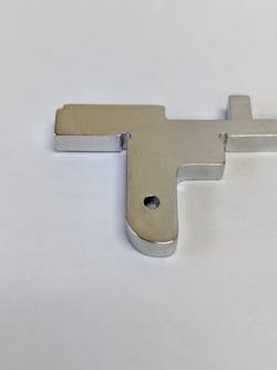 FIGURE 1. A 0.063-in.-diameter hole produced to a tolerance of ±0.001 in. and with smaller corner reliefs is shown. FIGURE 1. A 0.063-in.-diameter hole produced to a tolerance of ±0.001 in. and with smaller corner reliefs is shown.