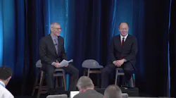 John Lewis (left) talks to the CEO and President of MKS Instruments, John Lee.
