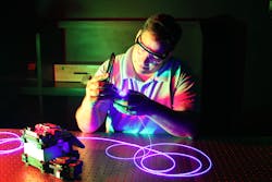 LASER-TEC student John Anderson terminates a single-mode fiber. LASER-TEC student John Anderson terminates a single-mode fiber.